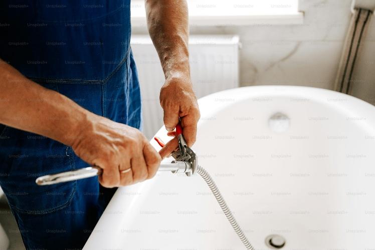 A technician busy with bathtub repair in Turlock at a residential property.